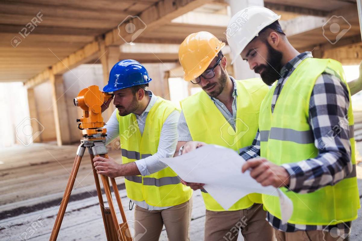 Portrait of construction engineers working on building site